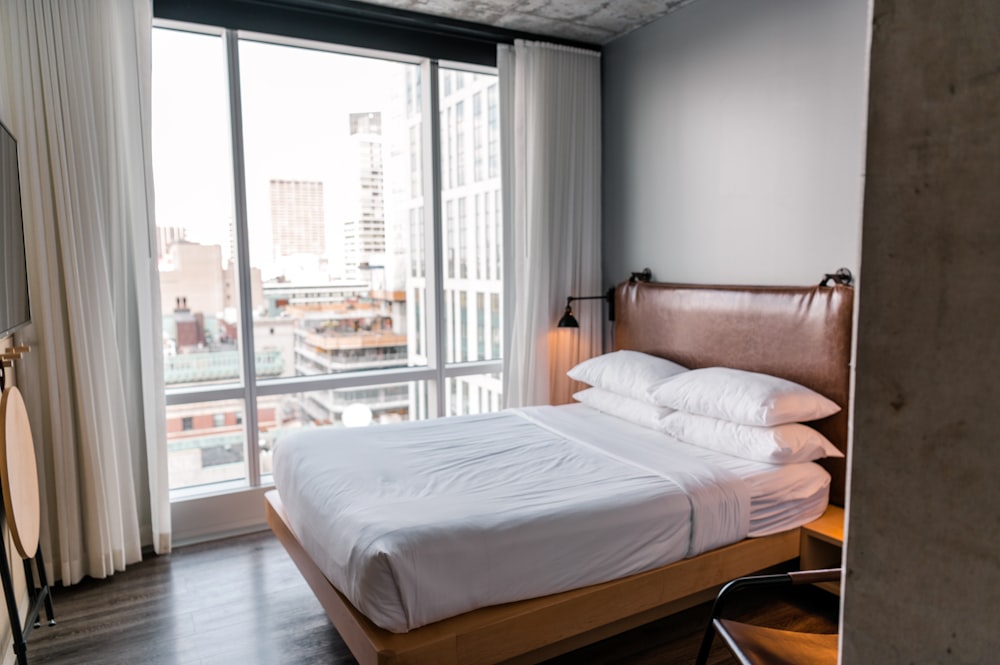 white bed linen on bed