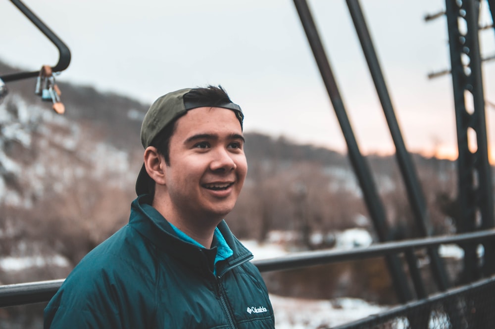 man in green jacket smiling