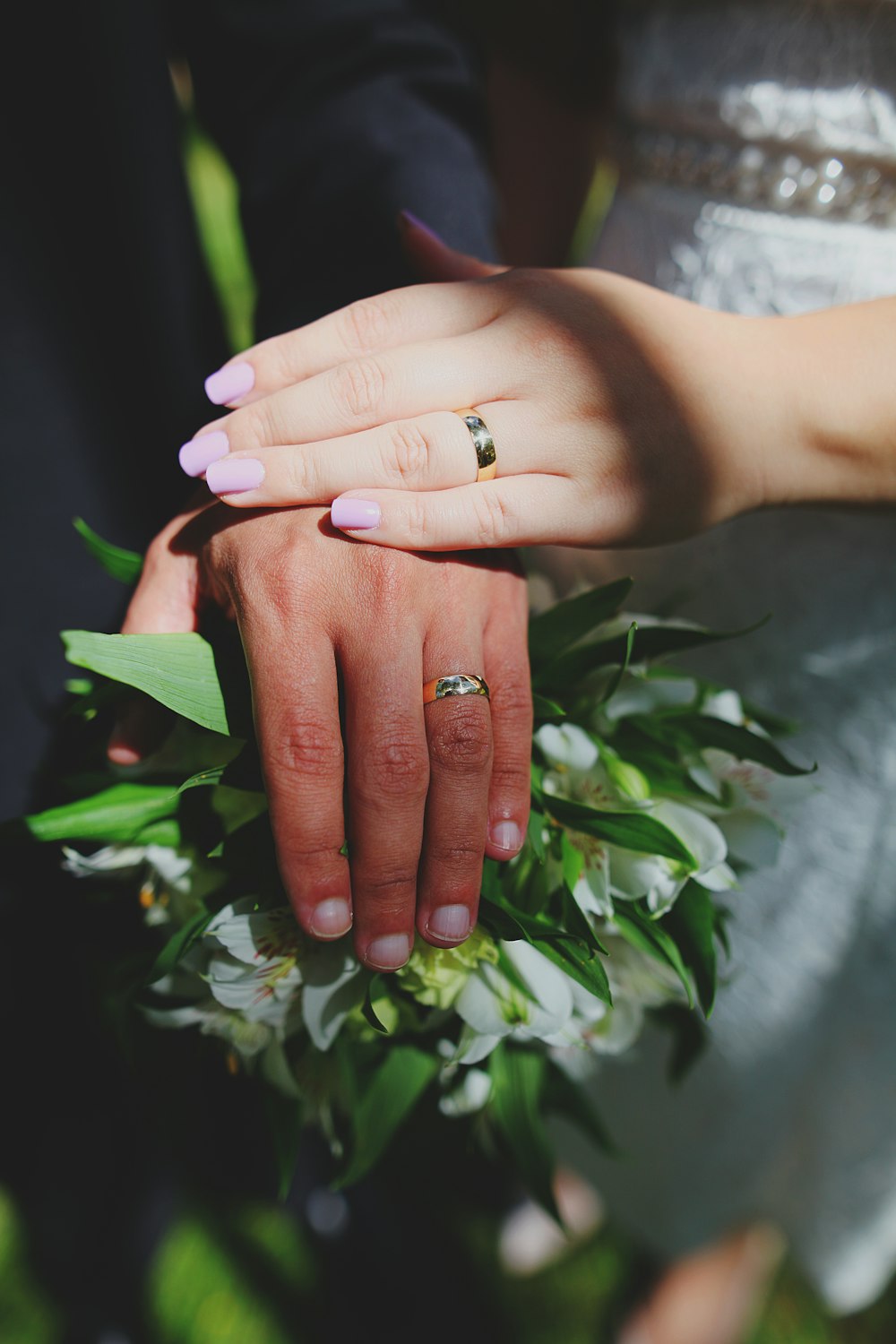 person with silver ring holding green plant