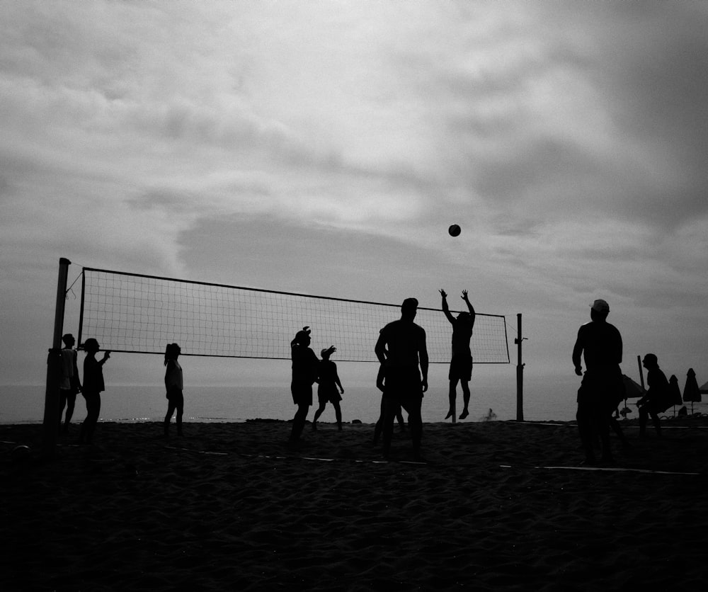 silhouette of people playing soccer during daytime
