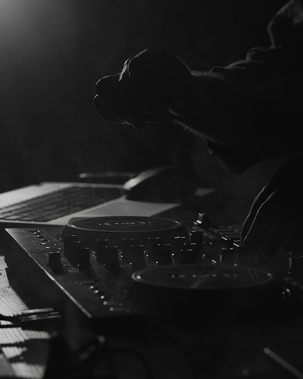 grayscale photo of person playing dj mixer