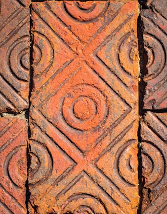 A close-up of handcrafted ceramic tiles in natural light.