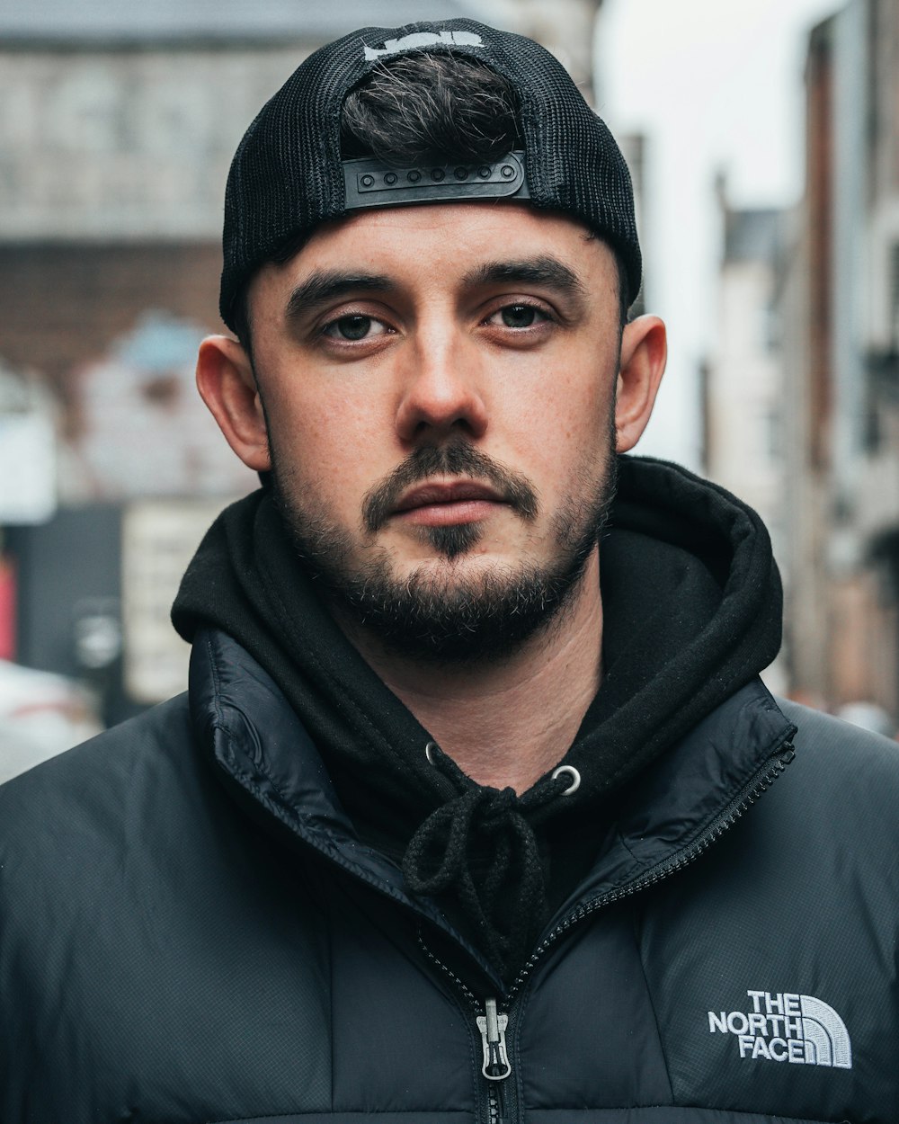 man in black zip up jacket and black knit cap