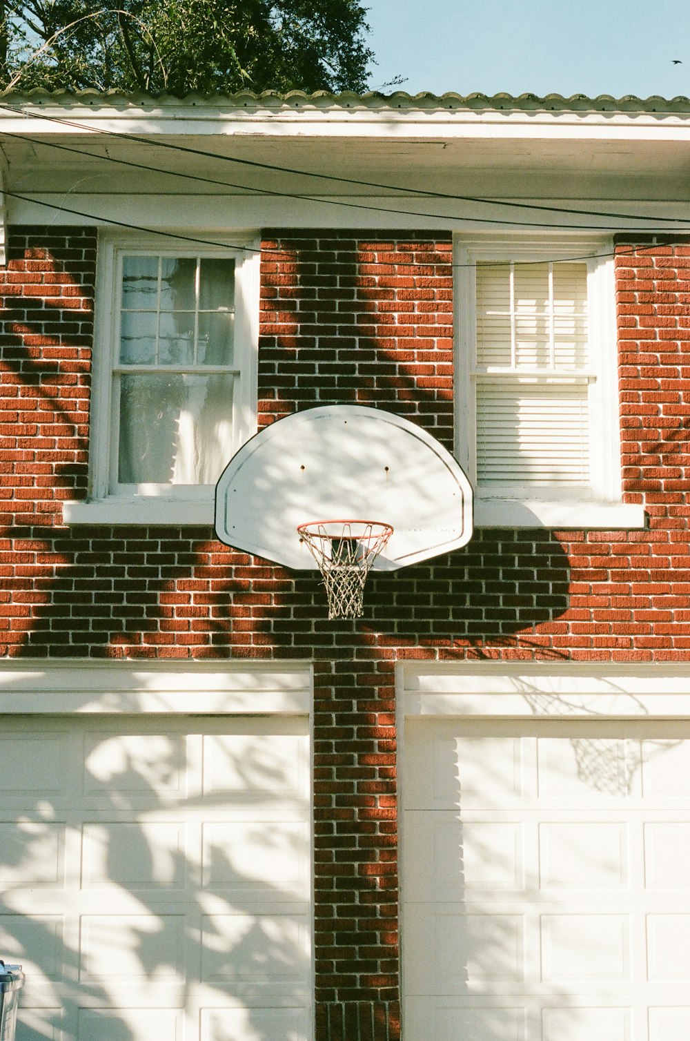 black and white basketball hoop on brown brick wall