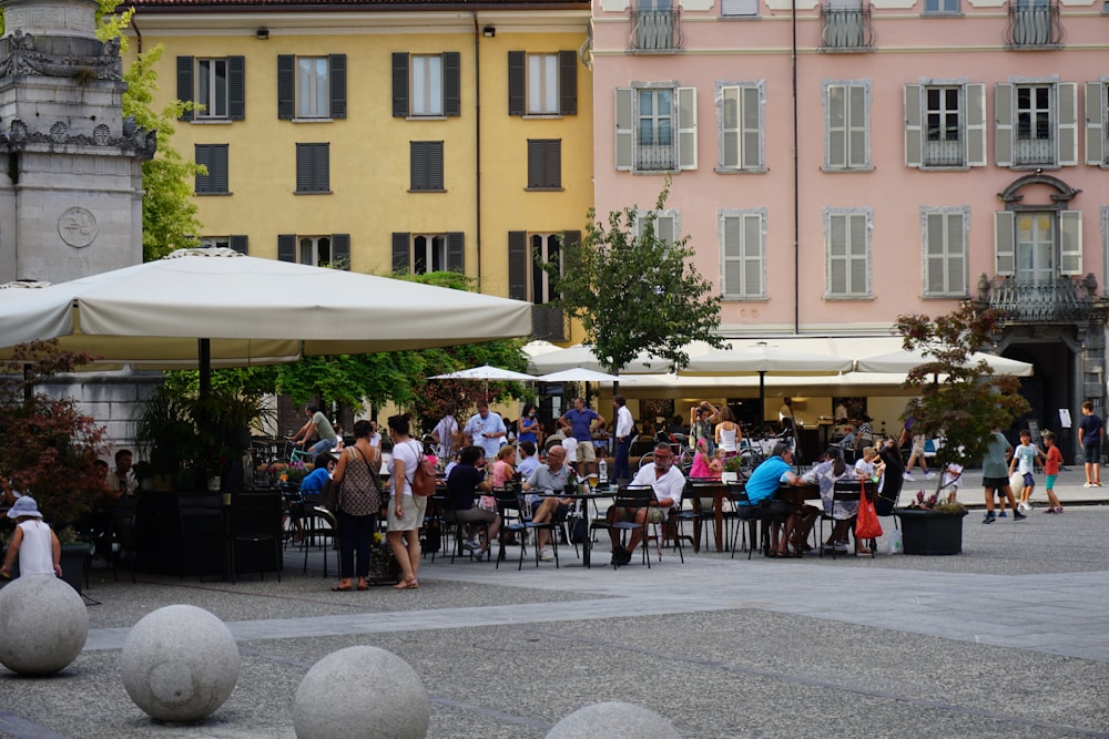 people sitting on chair near building during daytime