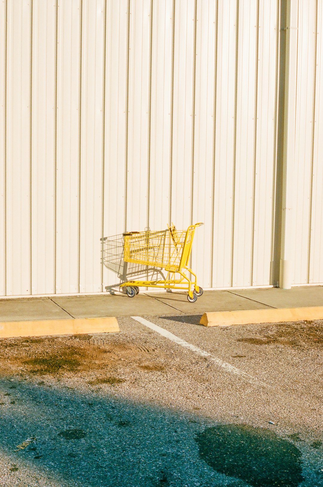 yellow shopping cart on gray concrete floor