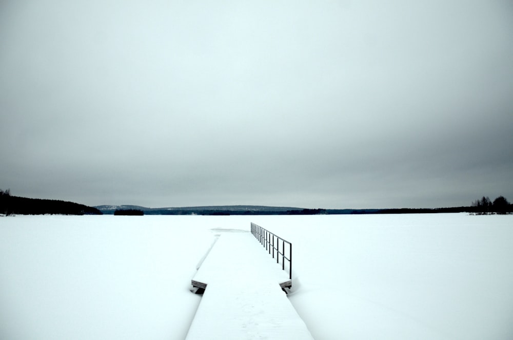 white and black wooden dock on white snow covered ground