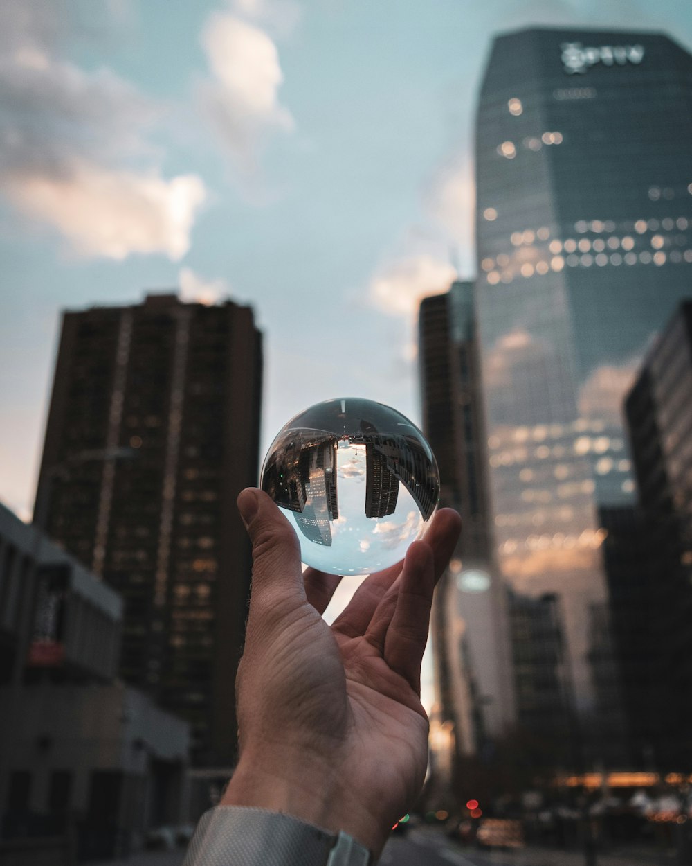 person holding clear glass ball