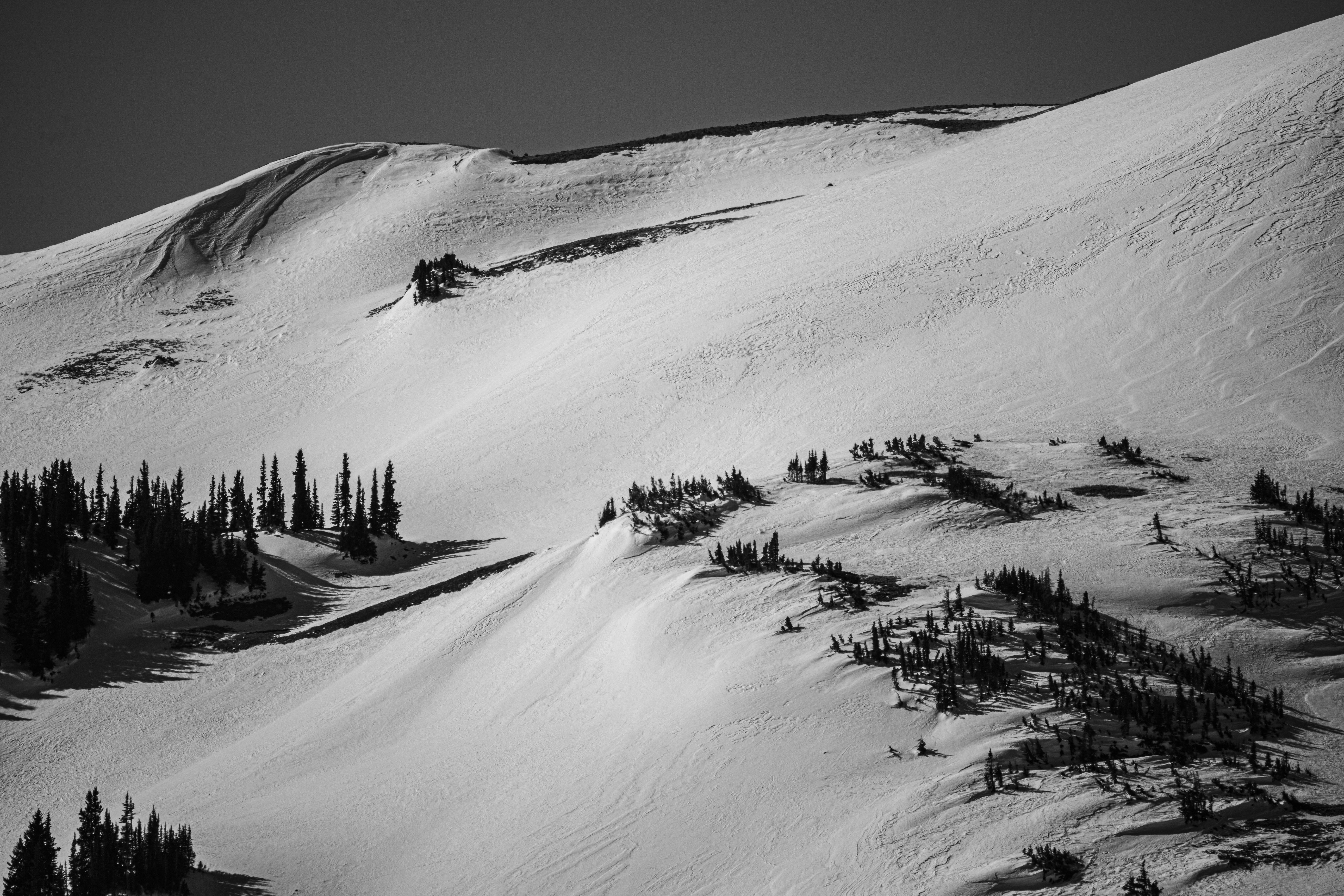 grayscale photo of snow covered mountain sublime teams background