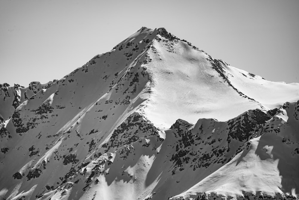 snow covered mountain under white sky