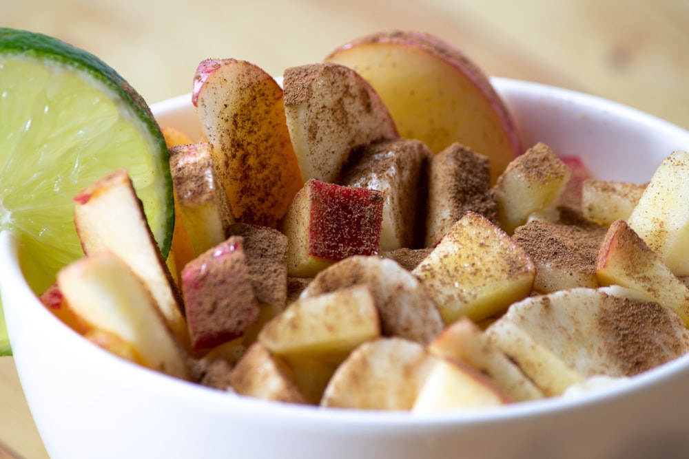 sliced fruit in white ceramic bowl