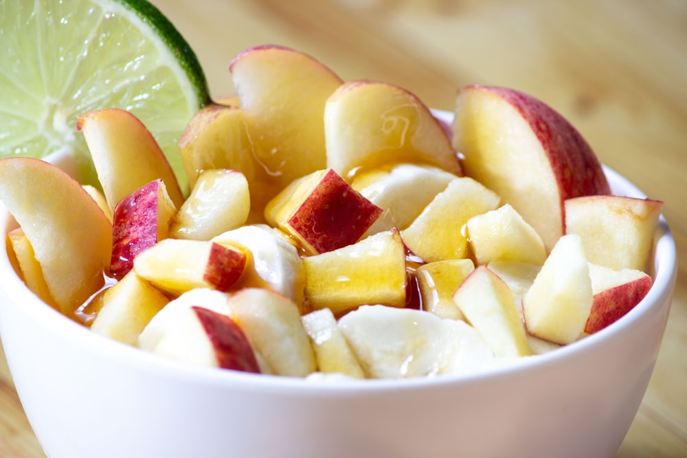 sliced fruits in white ceramic bowl