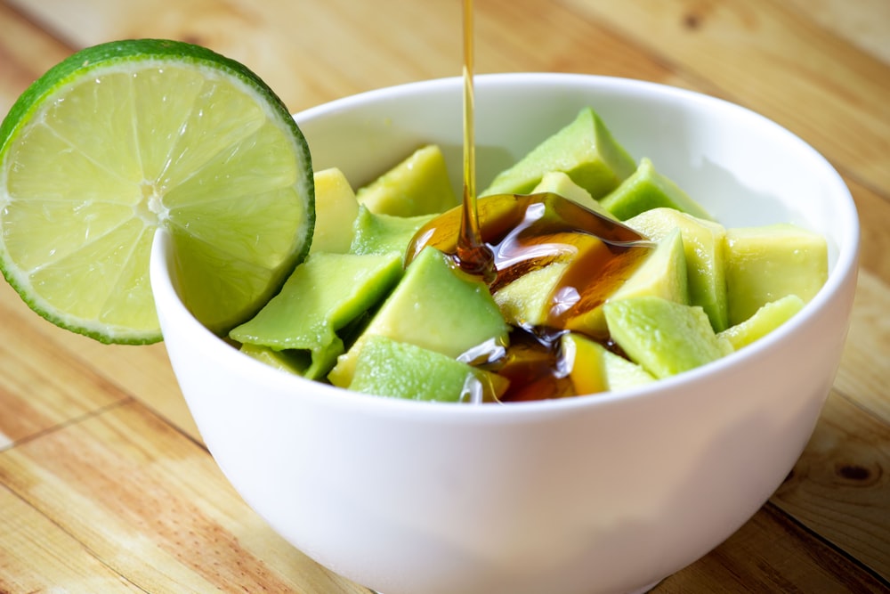 sliced cucumber in white ceramic bowl