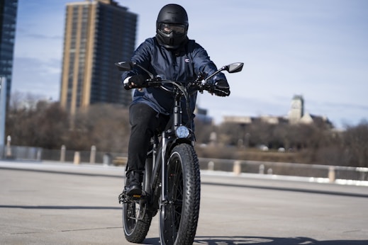 man in black motorcycle helmet riding motorcycle on road during daytime
