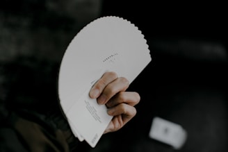 person holding white printer paper