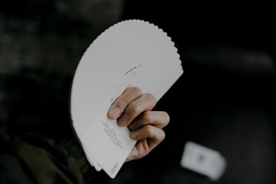 person holding white printer paper