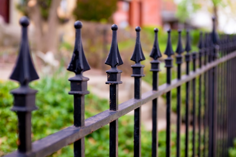 Wrought iron fence with ornamental scrollwork in front of home
