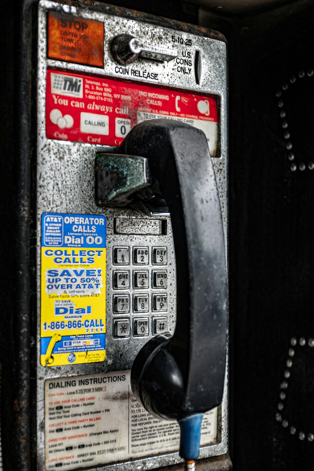 black and yellow telephone on black surface