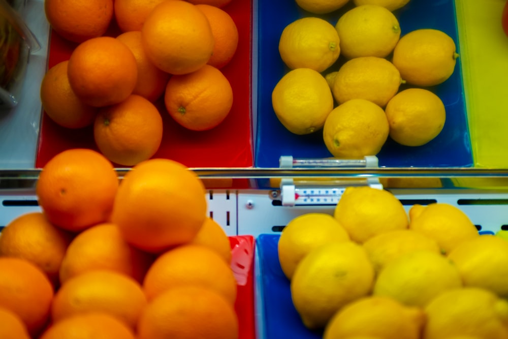 yellow citrus fruits on red and blue shelf
