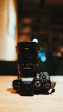 black nikon dslr camera on brown wooden table