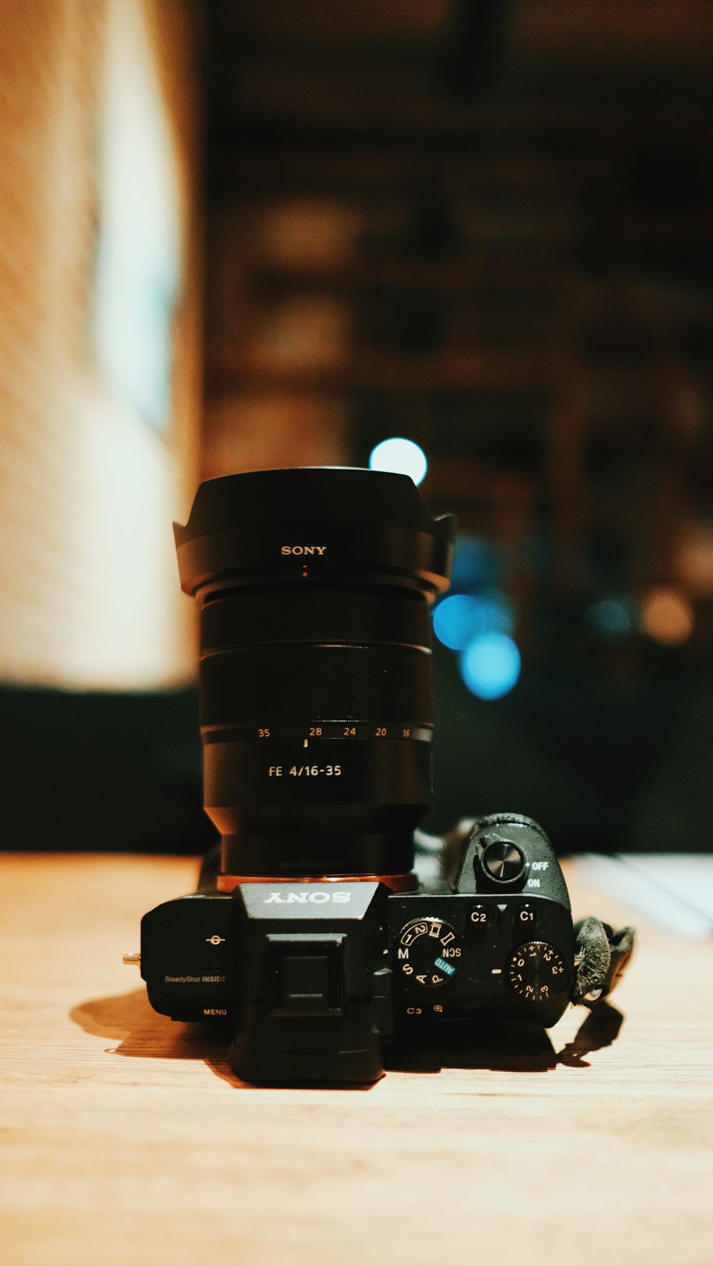 black nikon dslr camera on brown wooden table