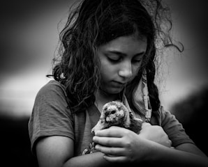 grayscale photo of woman holding dog
