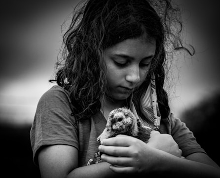 grayscale photo of woman holding dog