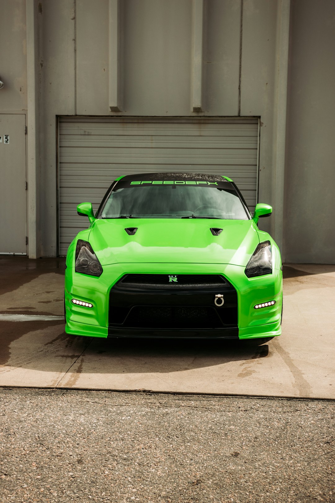 green porsche 911 parked in garage