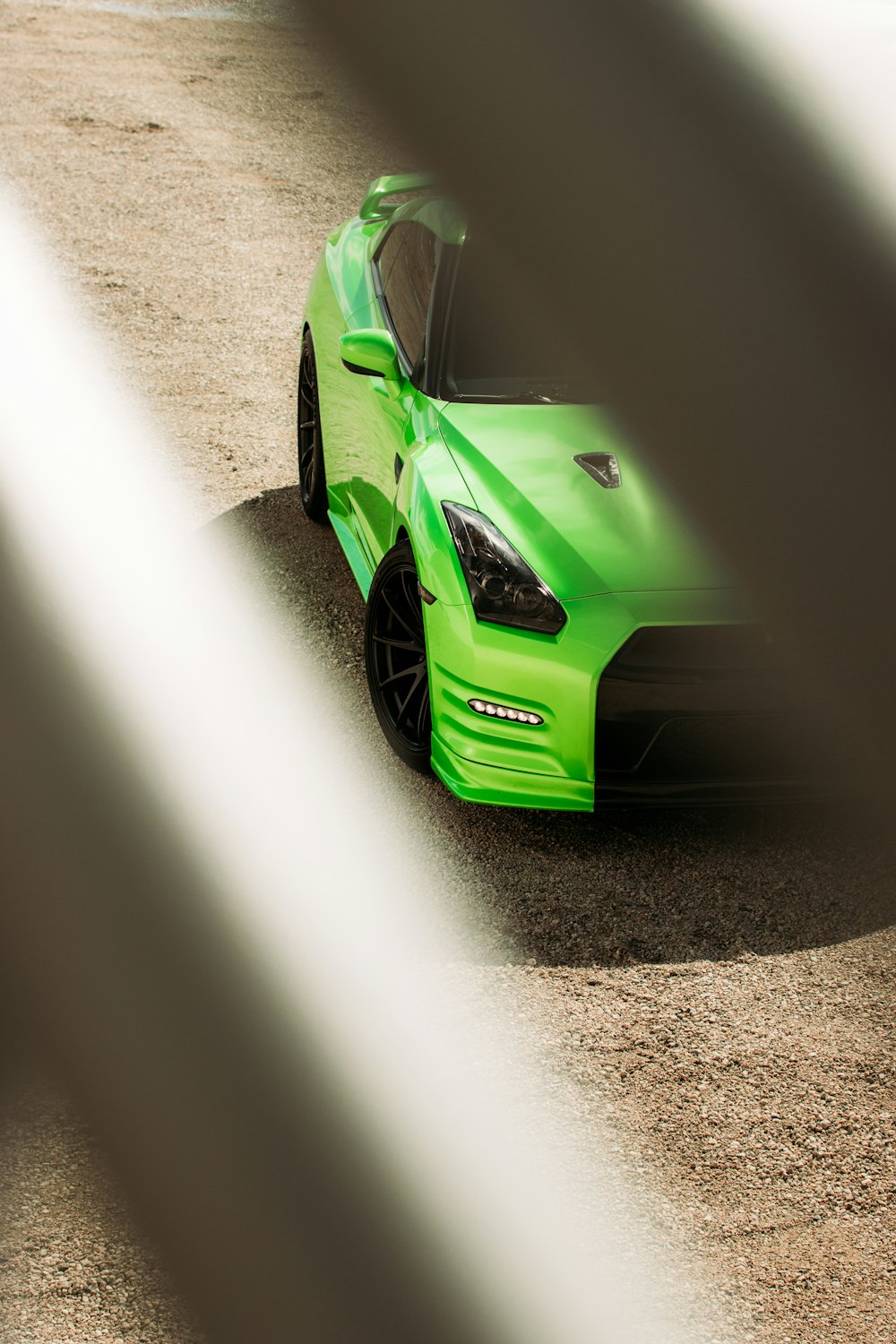 green car on gray asphalt road