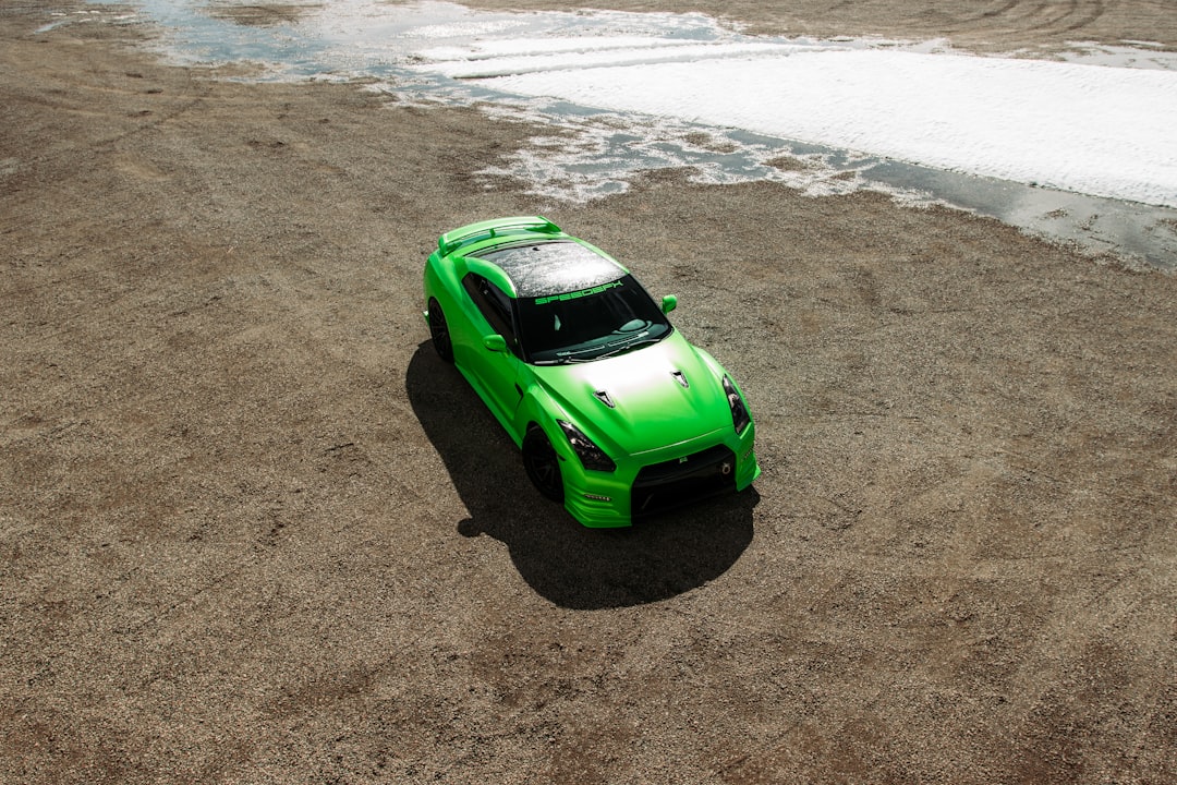 green car on beach during daytime