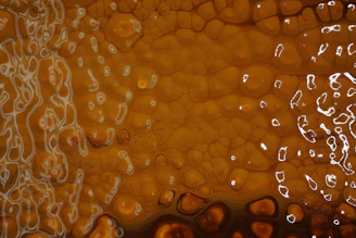 A rich amber gold honeycomb pattern rendered in saturated watercolor style.