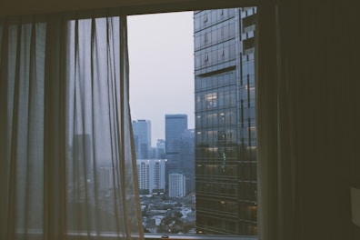 A beautiful view from a hotel room window overlooking the city.