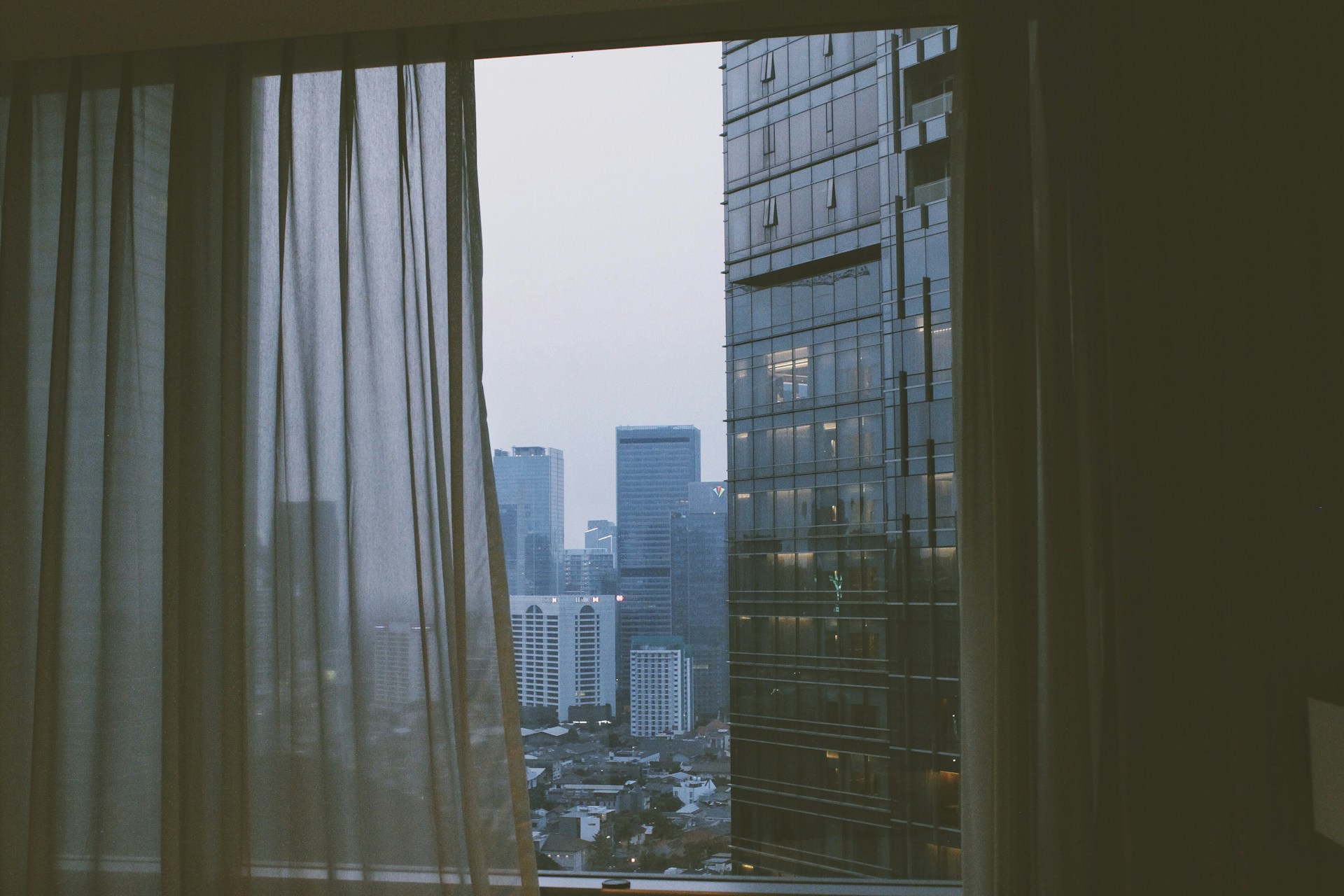 A calm cityscape view from a high-rise office window in Botafogo, Rio de Janeiro, symbolizing connection to the local market.