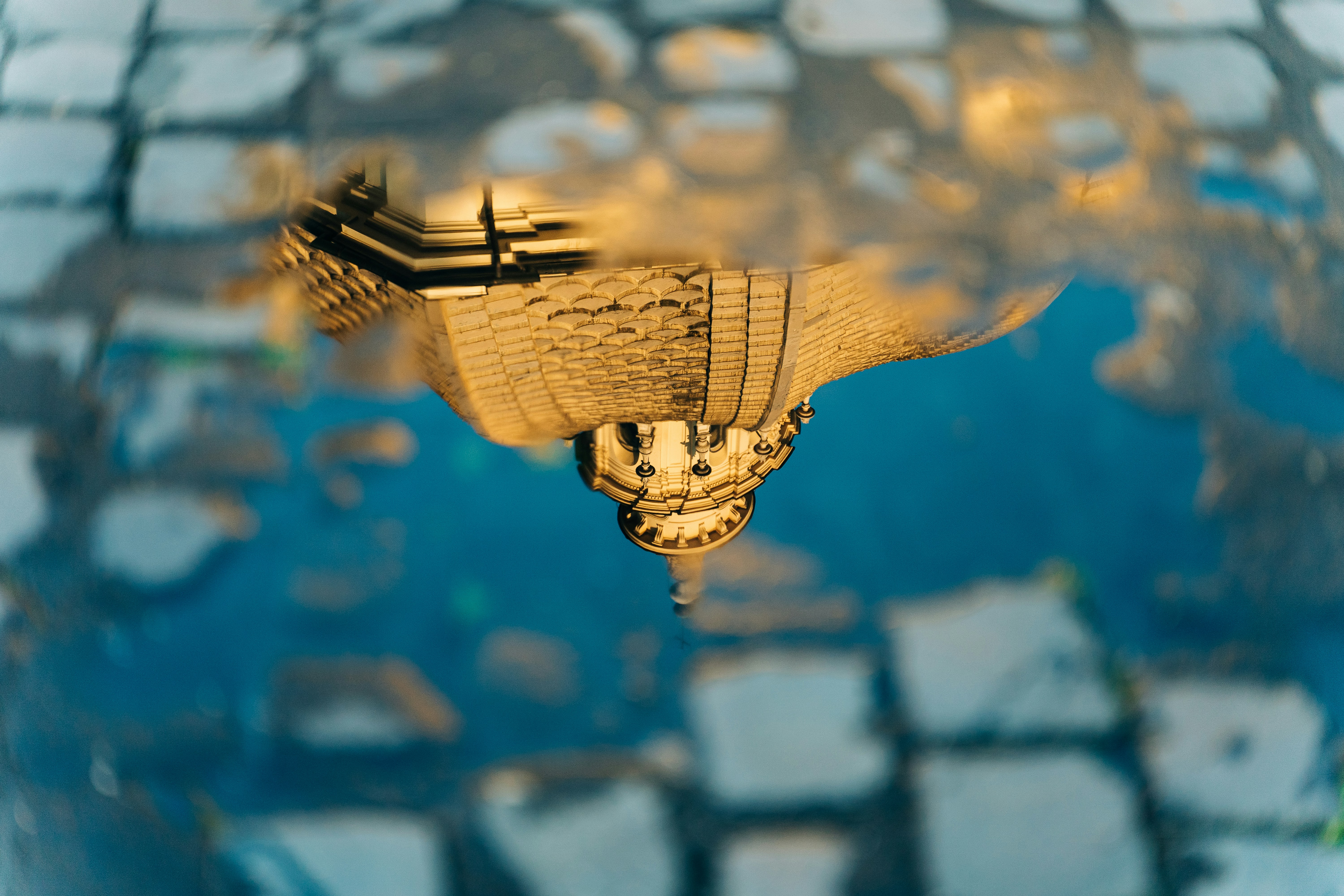 Church dome reflected in a puddle in the cobblestones in Rome, Italy