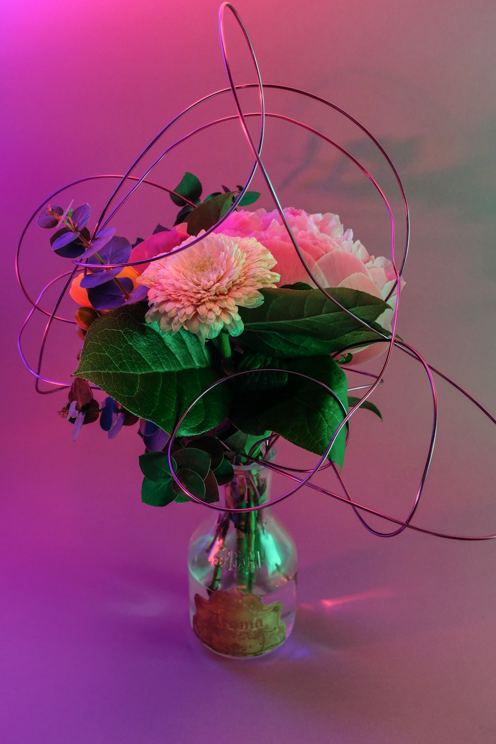 pink and white flower in clear glass vase