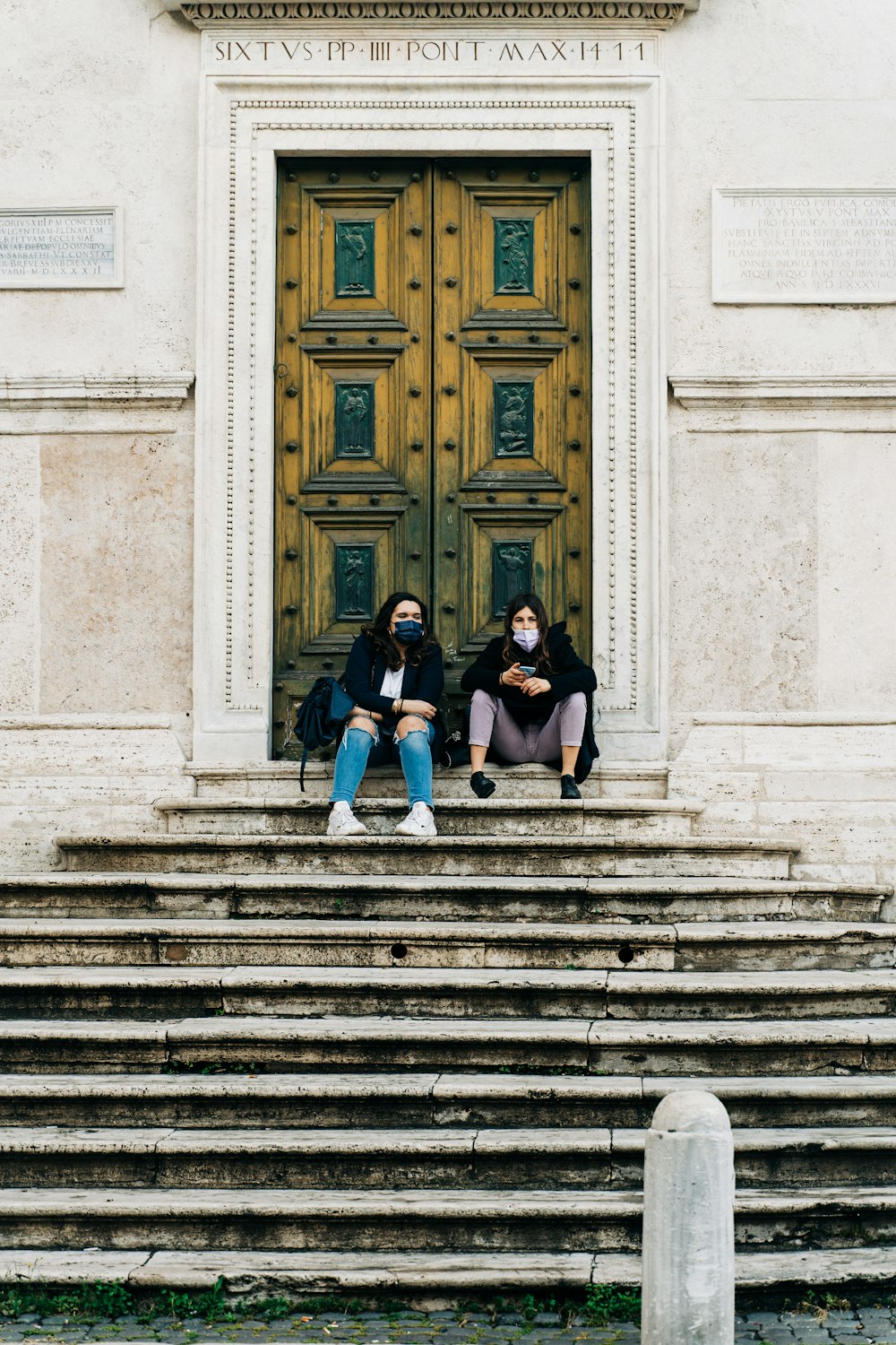 woman in black shirt sitting on stairs