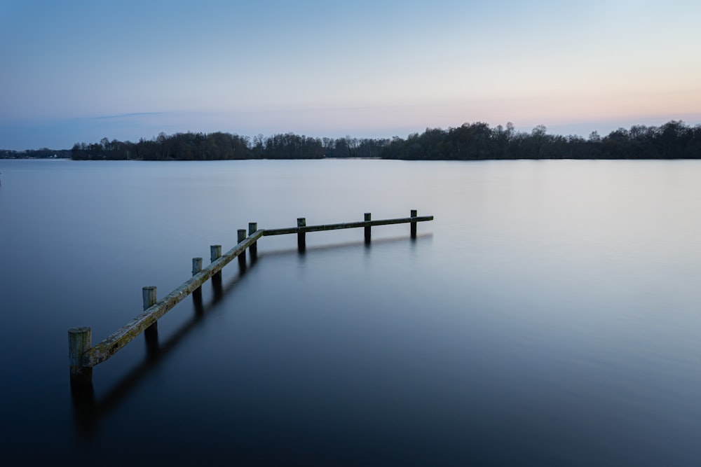 brown wooden dock on lake during daytime