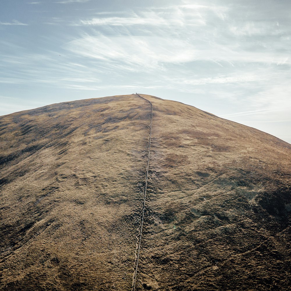 brown mountain under blue sky during daytime