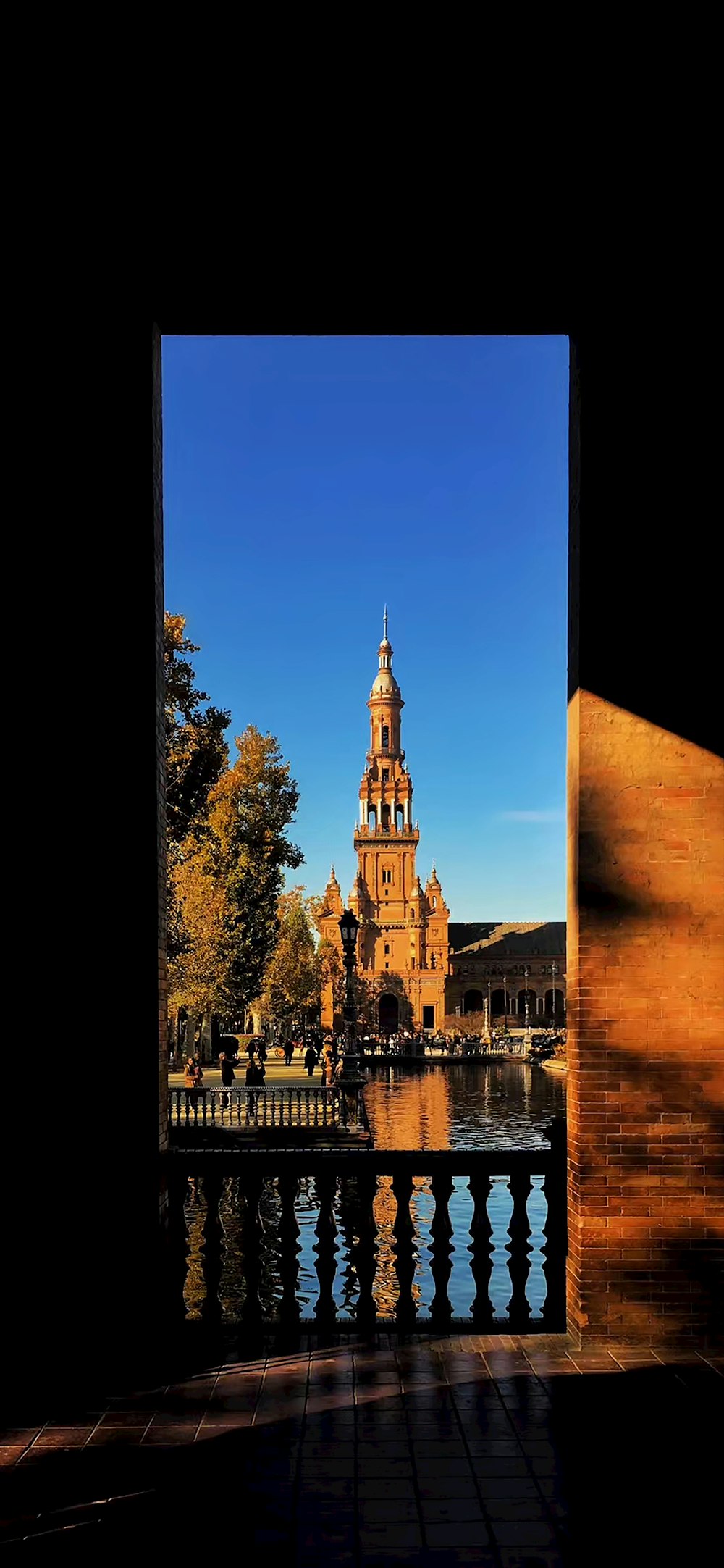 brown concrete building near body of water during daytime