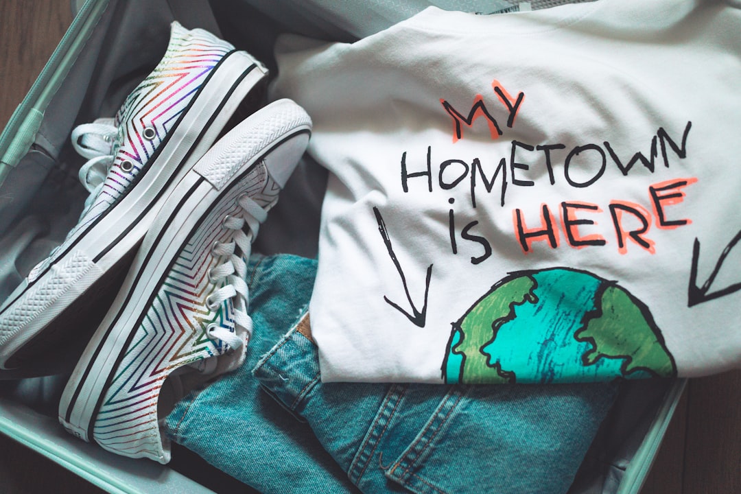 white and black shirt on blue denim jeans, Packing up a suitcase
