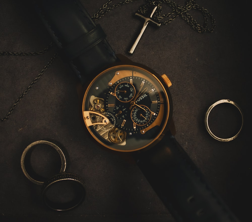 black and gold round chronograph watch