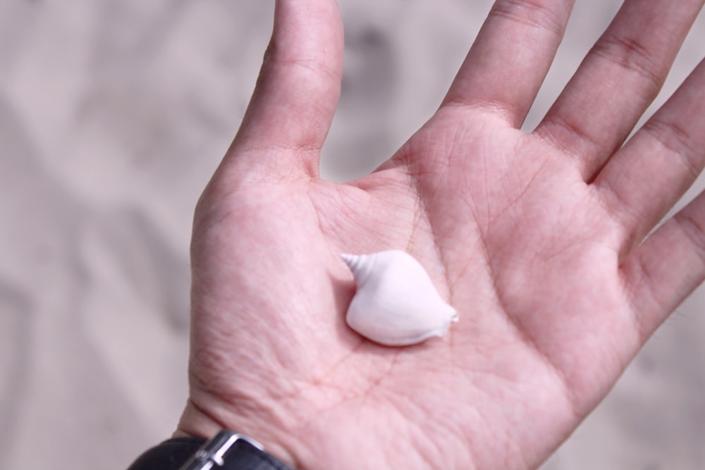 white plastic on persons hand