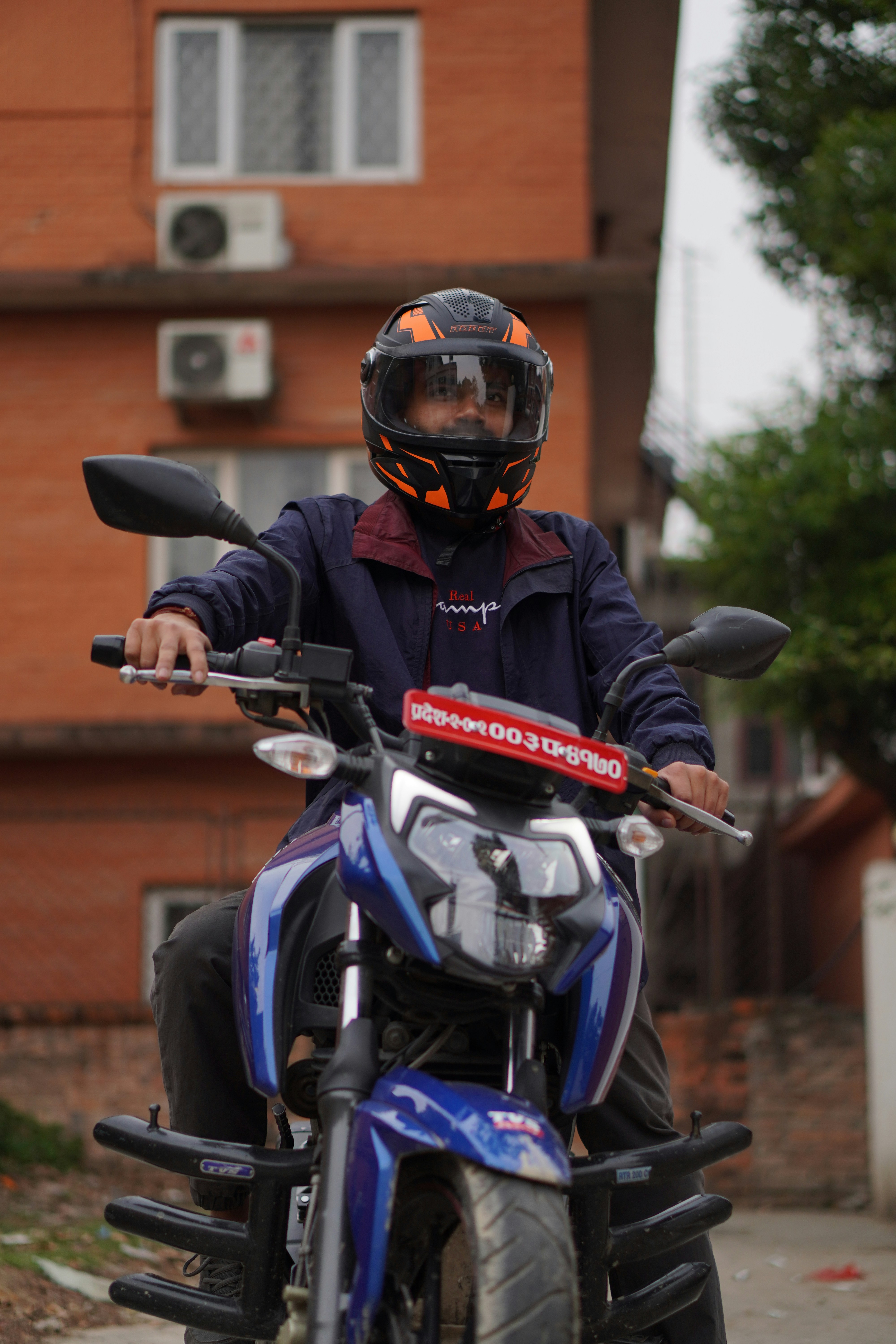man in black and red motorcycle helmet riding blue and black motorcycle