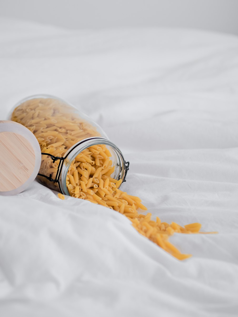 brown wooden jar on white textile