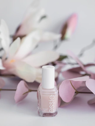 Elegant nail care setup featuring cream and blush tones with delicate floral decor.