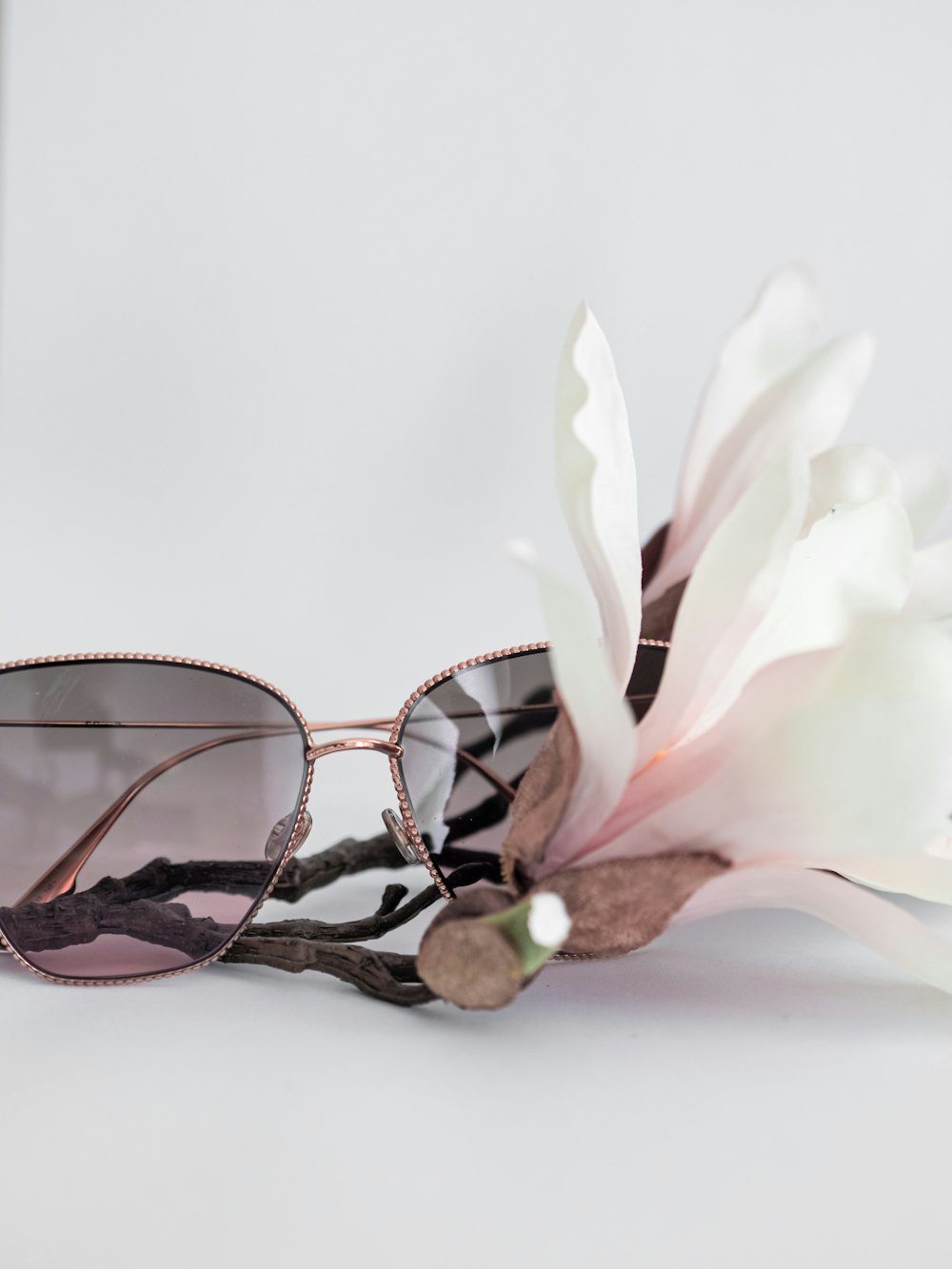 black framed eyeglasses on white flower