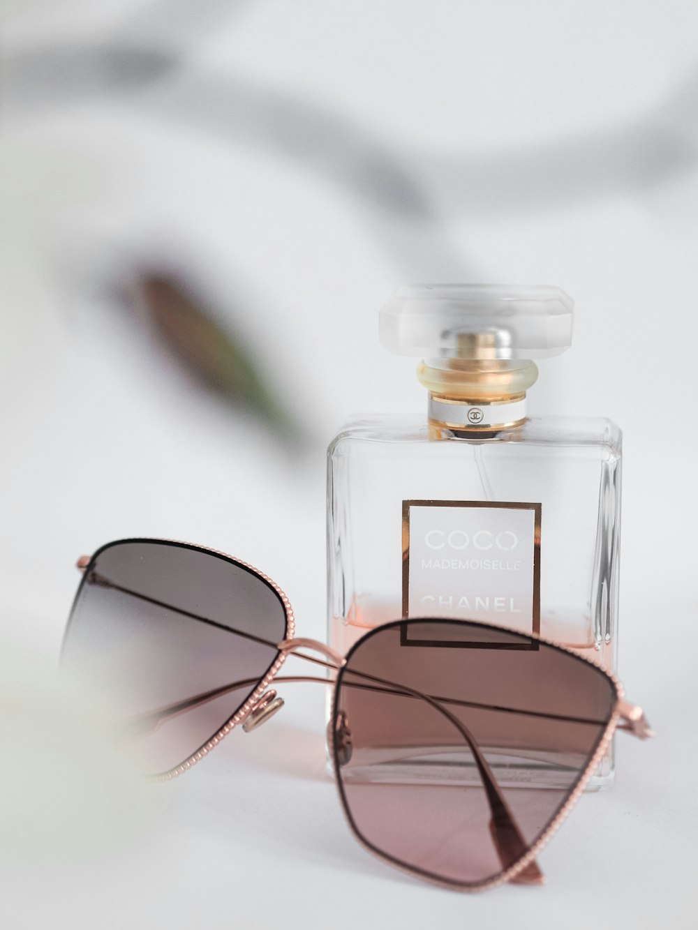 black framed sunglasses on clear glass bottle