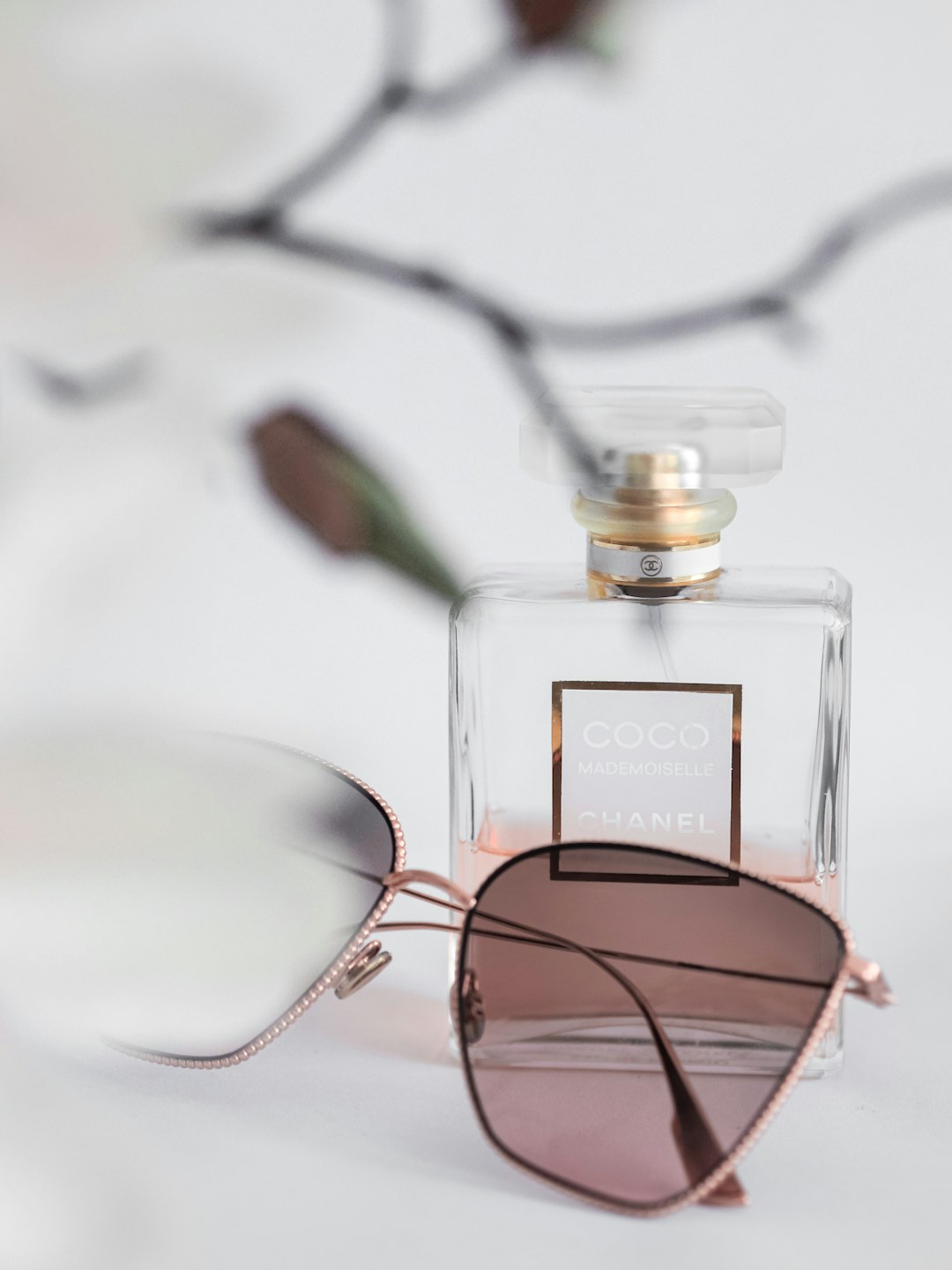 clear glass perfume bottle with brown frame sunglasses
