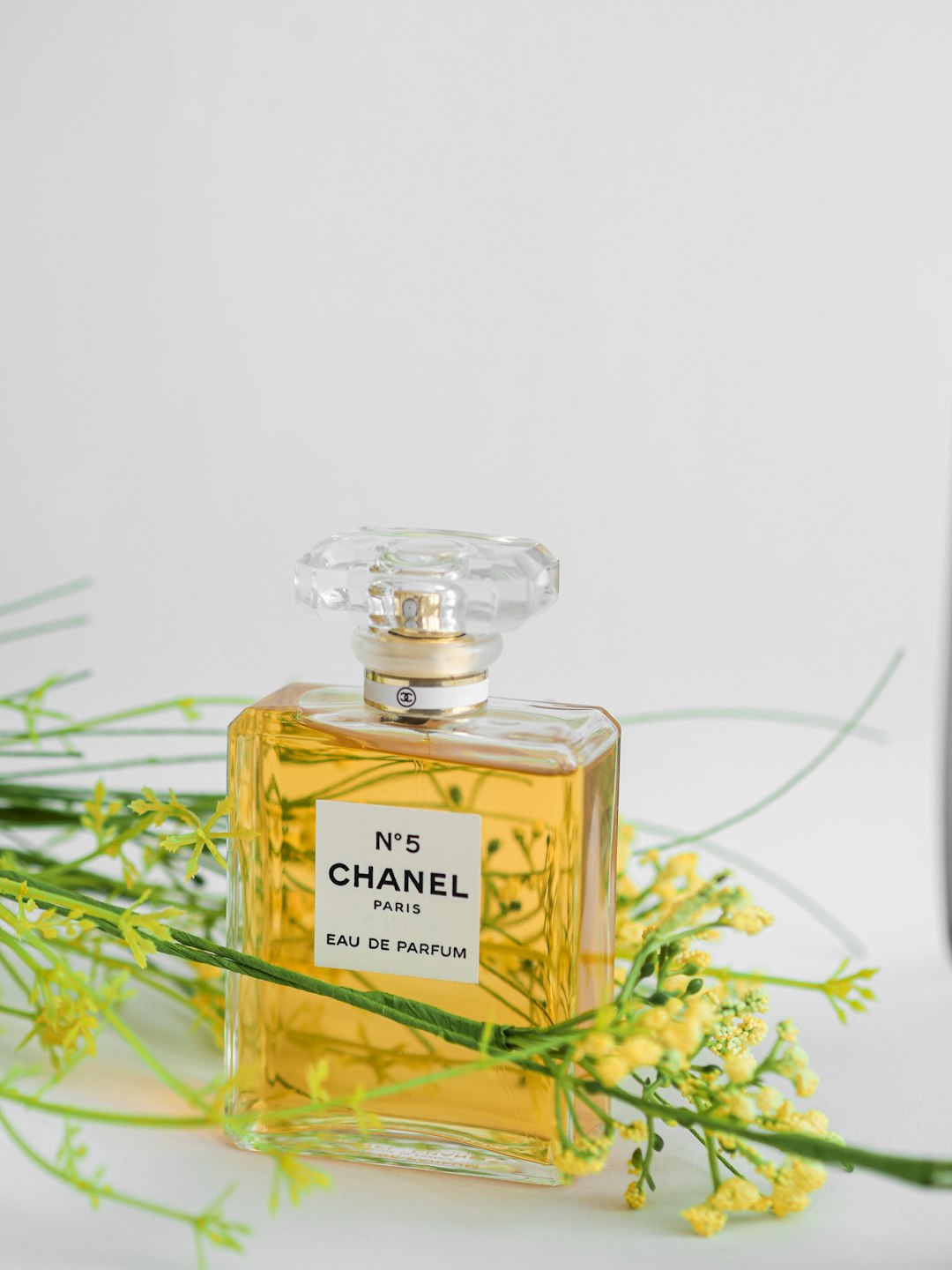 chanel paris perfume bottle on white surface