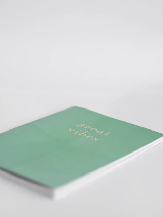 A white notebook cover featuring a delicate mandala with soft pastel colors symbolizing aura energy.